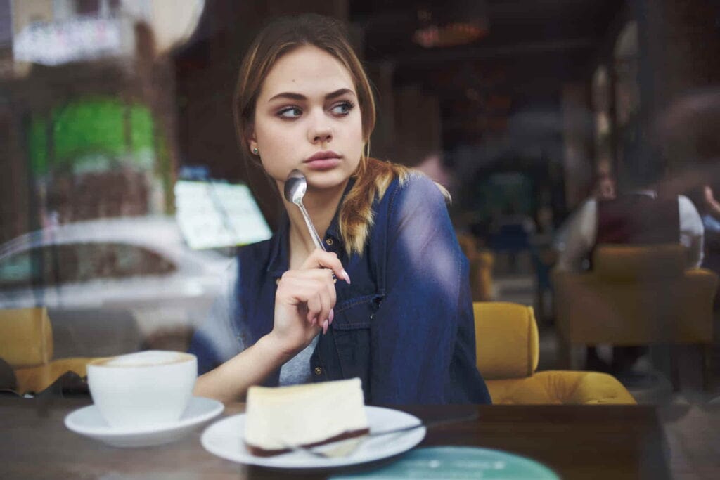 woman with an eating disorder-sitting-at-a-table